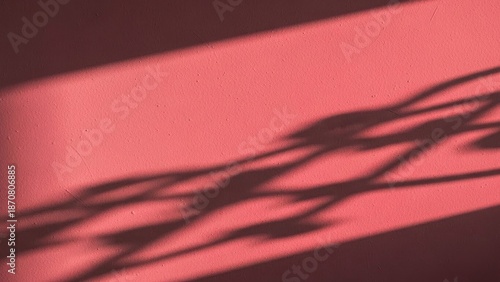 Valentine Abstract shadow pattern on textured pink stucco wall