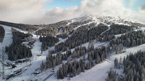 Travel and winter adventure concept. Aerial view of the ski resort. Kopaonik National Park, winter landscape in the mountains, coniferous forest covered with snow