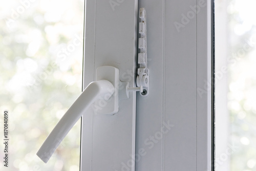 Obraz na plátně Close-up of a white pvc balcony door handle, an insulating glass window comb fixes the sash