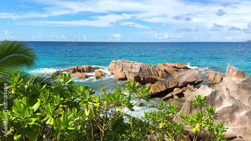 Explore rocky beach with clear water and green cliffs during sunny day