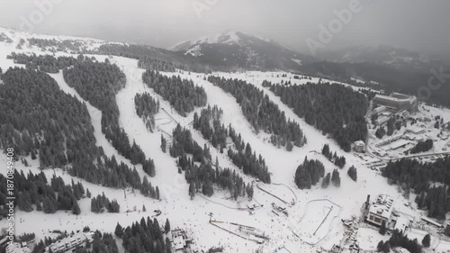 Travel and winter adventure concept. Aerial view of the ski resort. Kopaonik National Park, winter landscape in the mountains, coniferous forest covered with snow