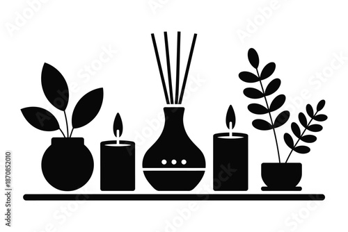 Aromatic diffusers and burning candles decorate a modern shelf.