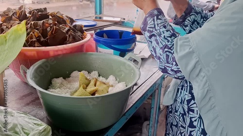 Culinary Craftsmanship on Display: Woman Preparing Traditional Delicacies with Care and Precision