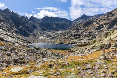 Laguna Grande de Gredos in Sierra de Gredos, landscape with high rocky mountains in the background, autumn view, Spain.