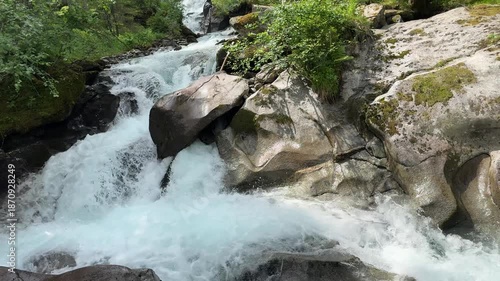 Rushing Waterfall in the Summer Austrian Alps at Koenigsleiten: A Powerful River Flowing Through Rocky Nature