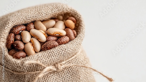 Mixed beans filling a burlap sack, representing healthy nutrition, plant based and agriculture protein, sustainable