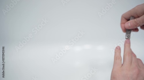 Cutting nails on a man's hand with nail tongs on a white background. Care for hands.
