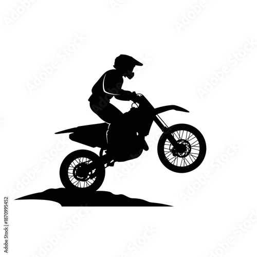 Motorcyclist performing stunt on dirt bike