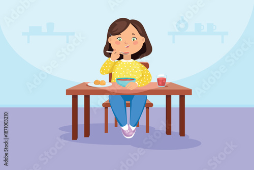 The girl eats sitting at the table