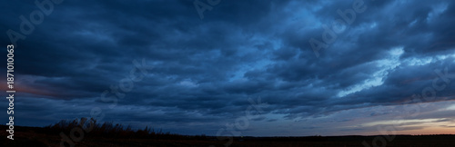 Photography A stunningly beautiful sunset sky and colorful clouds over a field of mown corn