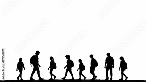 Silhouette of a group of hikers walking together on a path.