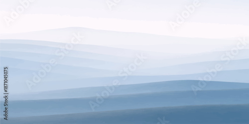 A serene morning view of a misty mountain valley landscape under a blue sky with soft clouds at sunrise, revealing the natural beauty of the forest hills and fog