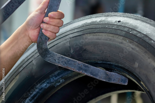 At the tire retreading factory, the tires are suspended on production racks awaiting the retreading process.