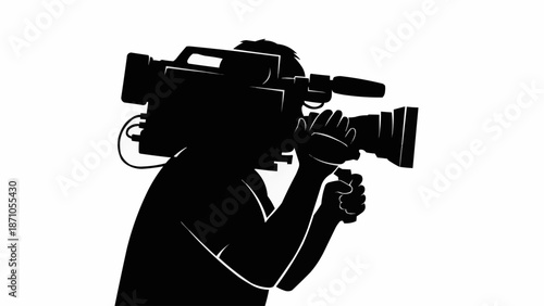 Silhouette of a videographer holding a professional video camera.