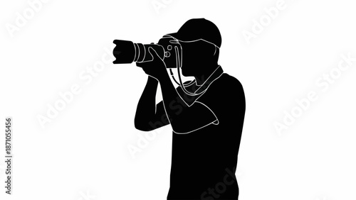 Silhouette of a photographer holding a camera and taking a picture.