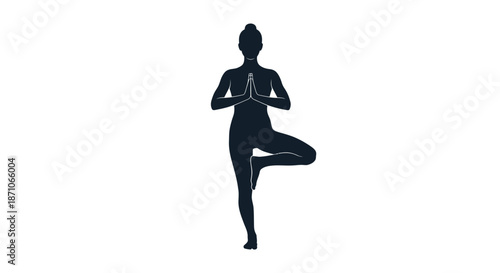 A dark silhouette of a woman practicing yoga in the balanced Tree Pose Vrksasana.