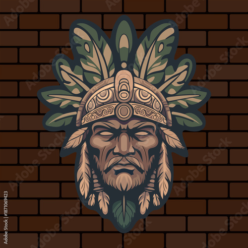 a stern face of a tribal Indian warrior or deity with stylized leaves on his head depicted on a brick wall