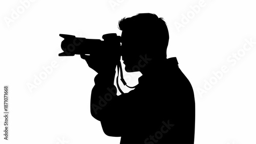 Silhouette of a photographer holding a professional camera and taking a photo.