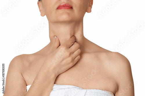 Woman touching her throat and neck, concept of sore throat, thyroid problem, swallowing pain on white