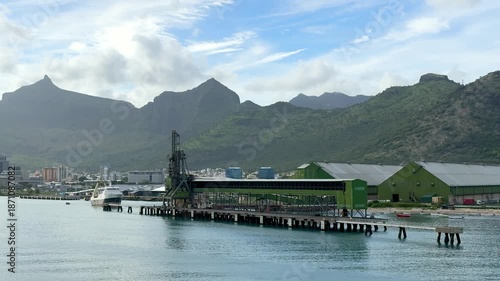 Port facility located by the water with loading equipment in action during daytime