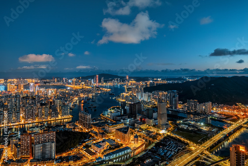 Aerial view of the vibrant city skyline and harbor at night in Macau.