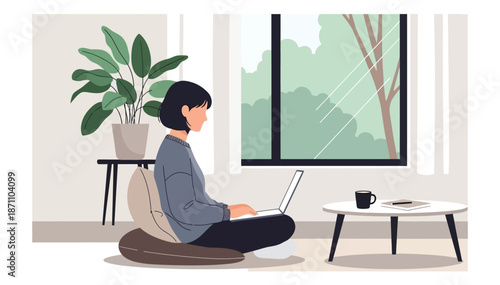 Woman working on laptop at home by window in daylight with plant and coffee cup minimal setup