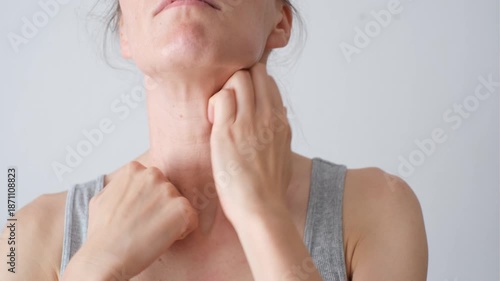 A person performs a therapeutic massage using their ankles on another person’s neck. Concept of wellness, muscle relaxation, and alternative treatment methods.