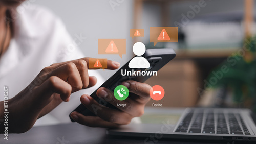 Schilderij op canvas Close up of hands holding smartphone with unknown incoming call alert and warning icons, representing scam protection, cyber security and digital fraud prevention in modern office