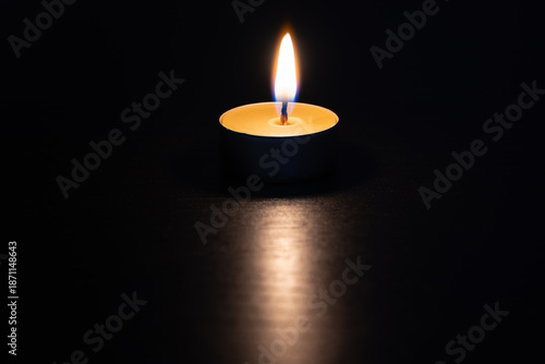 Photos Burning candle in the dark - symbol of hope, safety, care and remembrance