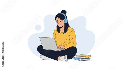 Young woman sitting cross-legged on the floor while using a laptop and wearing headphones next to a stack of books.