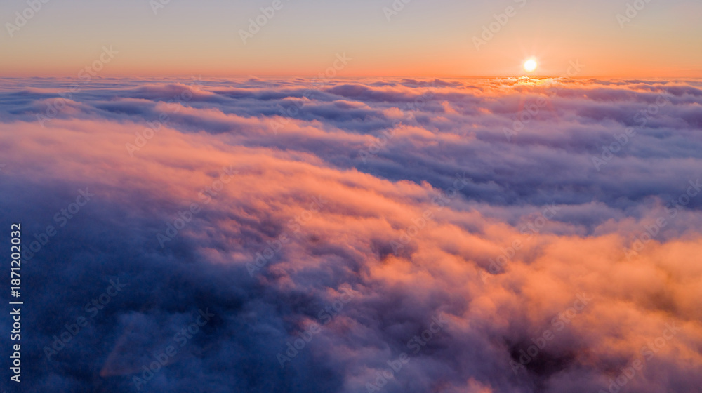 Fototapeta premium Beautiful Sunset with Purple Tint , Aerial Shot Above Clouds