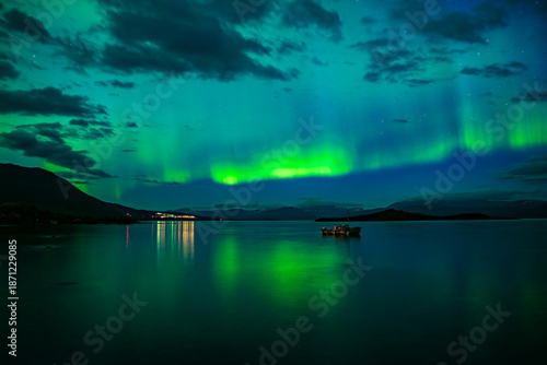 Bild auf Leinwand Northern lights dancing over calm lake in Abisko national park in north of Swede