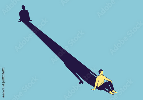 Man sitting with a long shadow stretching behind him.