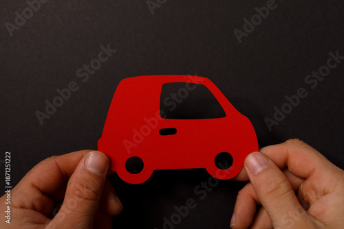 Hand holding a red paper cu...