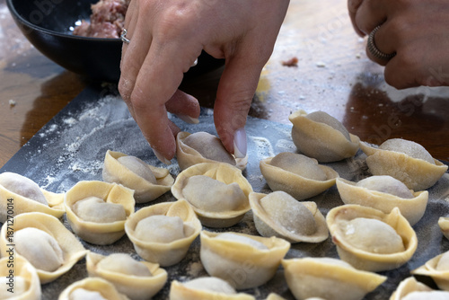 Foto Beef dumpling and dough on a board for dinner preparation.