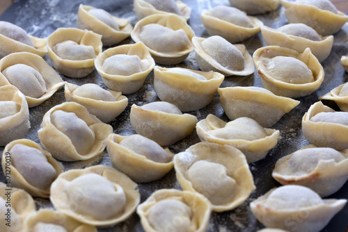 Tableau sur toile Beef dumpling and dough on a board for dinner preparation.