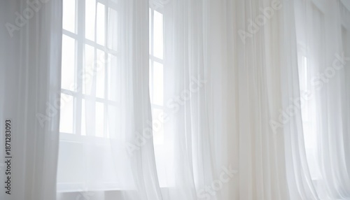 Sheer white curtains gently drape across a bright window with multiple panes Soft daylight illuminates the room