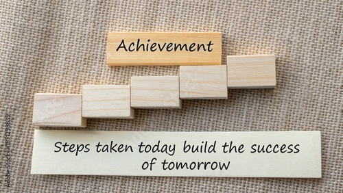 Wooden blocks form an ascending staircase representing achievement and steps for future success.