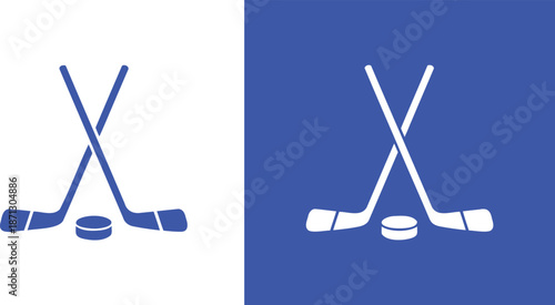 Two blue hockey sticks crossed with a puck sport game