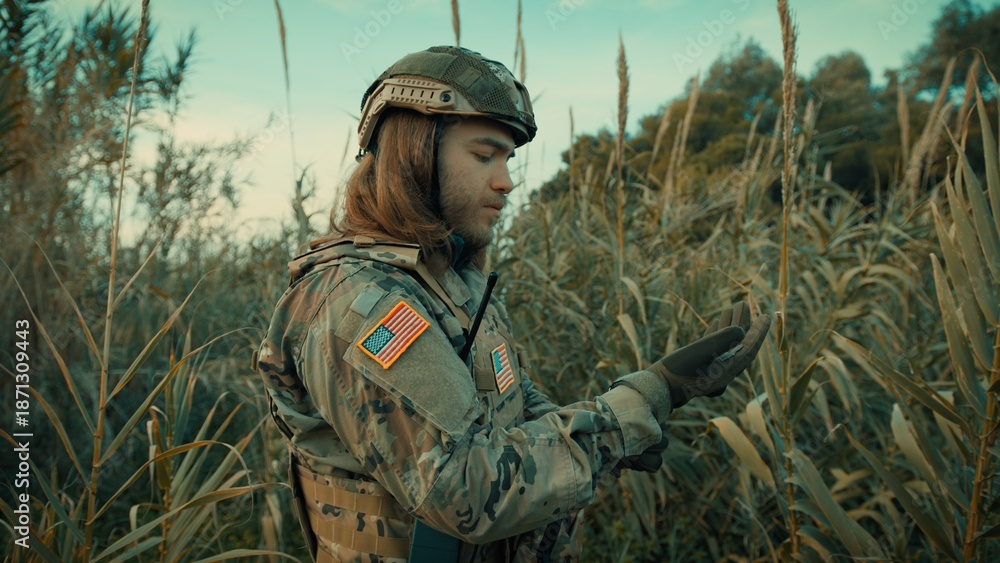 Fototapeta premium American soldier with long hair in a forest