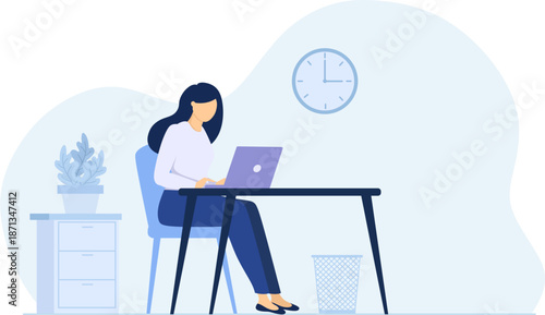 Young woman working on laptop at desk in modern office.