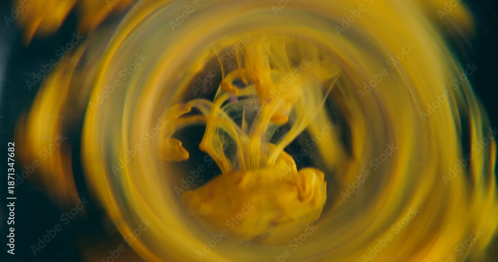 Obraz premium Dye blot blur. Vapor whirl. Circle color lens underwater splash. Yellow ink drop trickles spill on black abstract frame art background.