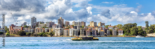 Panorama of the prime residential real estate of the Sydney Harbour Lower North Shore, with ferry boat, on a summer afternoon. The suburban districts of Kirribilli and Beulah Street Wharf
