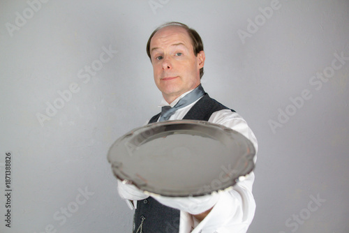 Obraz na plátne Butler or Waiter Holding Serving Tray in Elegant Manner