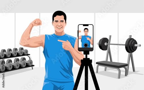 Strong athletic man recording fitness video on smartphone in gym showing bicep muscles for online training program professional influencer content creator social media vlogging for healthy lifestyle w