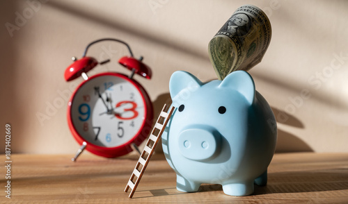 Fotografie Blue piggy bank with ladder and $1 bill