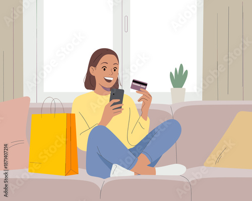 Happy woman using smartphone for online shopping with credit card from home sitting on sofa with shopping bag modern lifestyle e-commerce consumerism digital payments purchase retail therapy convenien
