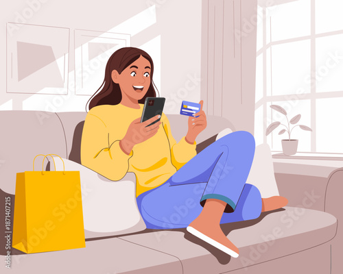Happy young woman using smartphone for online shopping holding credit card sitting on sofa at home cheerful female browsing internet buying purchase retail sales concept for ecommerce advertising and