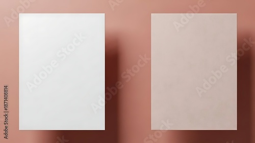 Two blank white sheets on a pink surface viewed from directly above