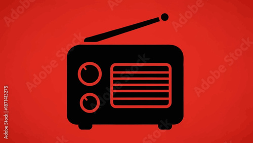 Retro black radio receiver with antenna on a solid red background, vintage electronic device for broadcasting music.
